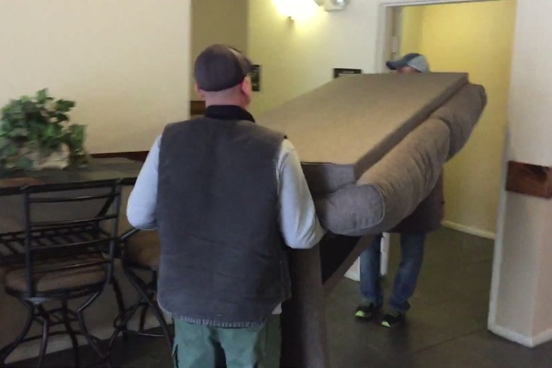 Carrying a sofa through the house